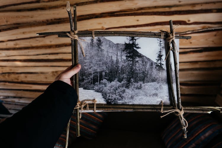 Person Holding A Wooden Picture Frame