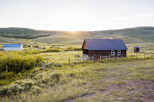 Brown Wooden Barn on Green Grass Field