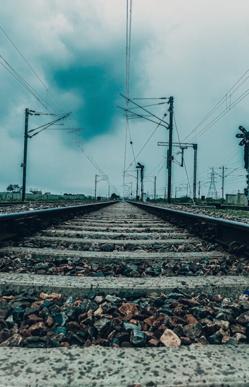 Free A Railway Track under a Cloudy Sky  Stock Photo