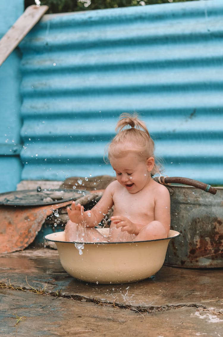 Little Girl Taking A Bath In A Metal Tub Outdoors 