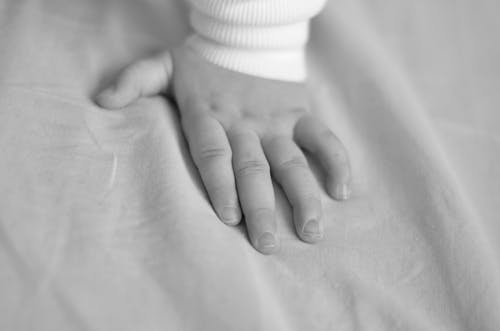 Free 
A Grayscale of a Child's Hand Stock Photo