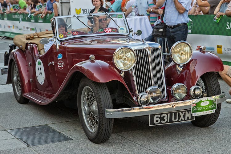 
Men Riding A Vintage Convertible Car