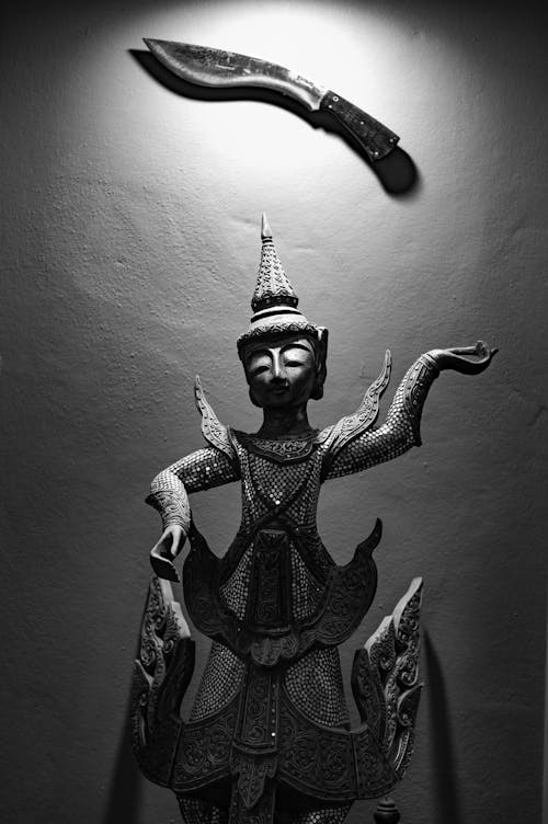 Buddha Figurine with a Sword in Black and White