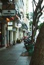 A Shops with Signages Near the Sidewalk