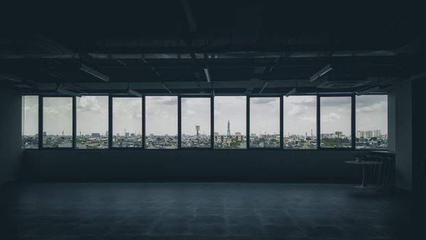 Spacious empty loft with a panoramic view of Ho Chi Minh City skyline through large windows.