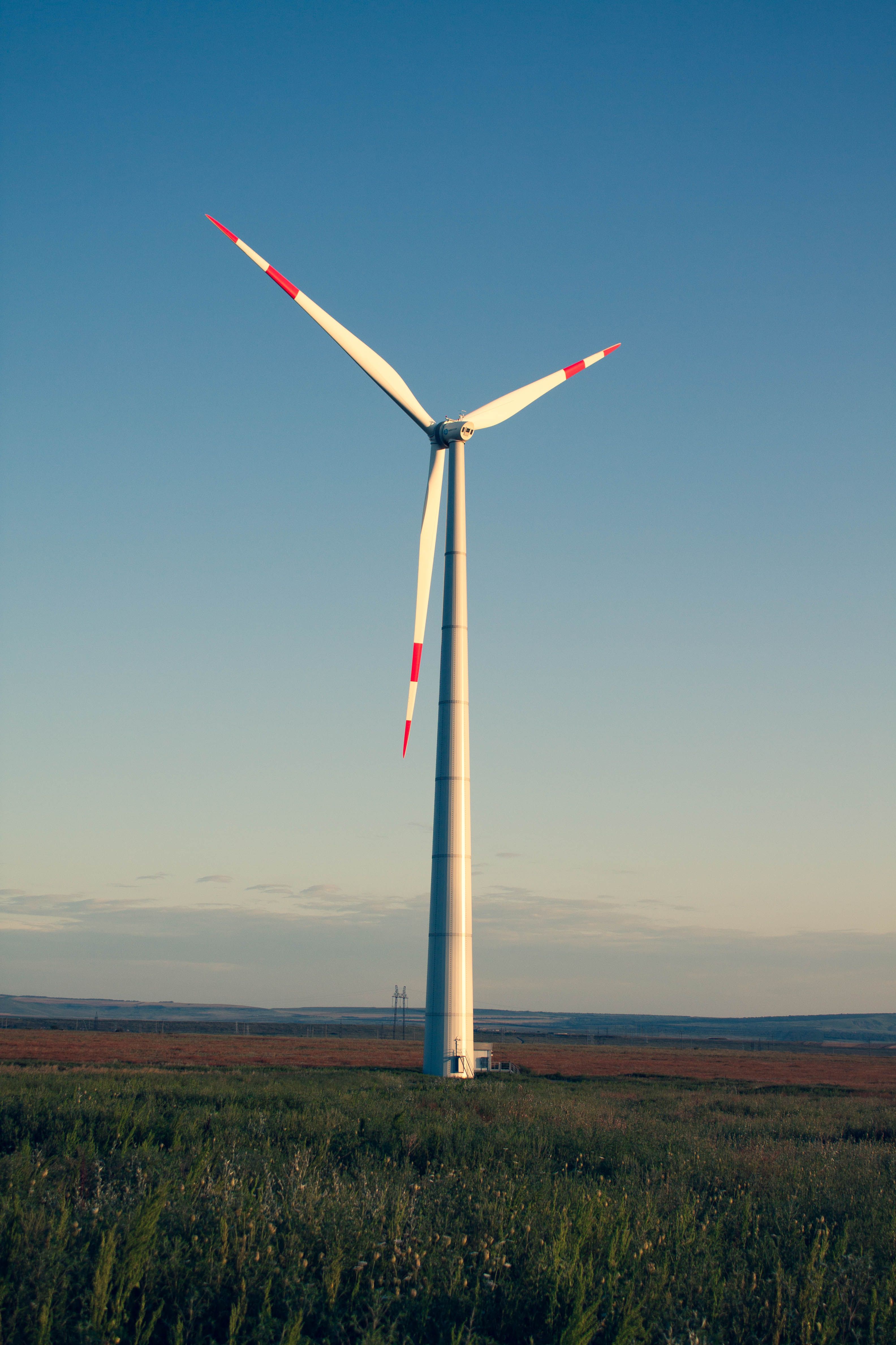 A White Windmill on a Grassy Field · Free Stock Photo