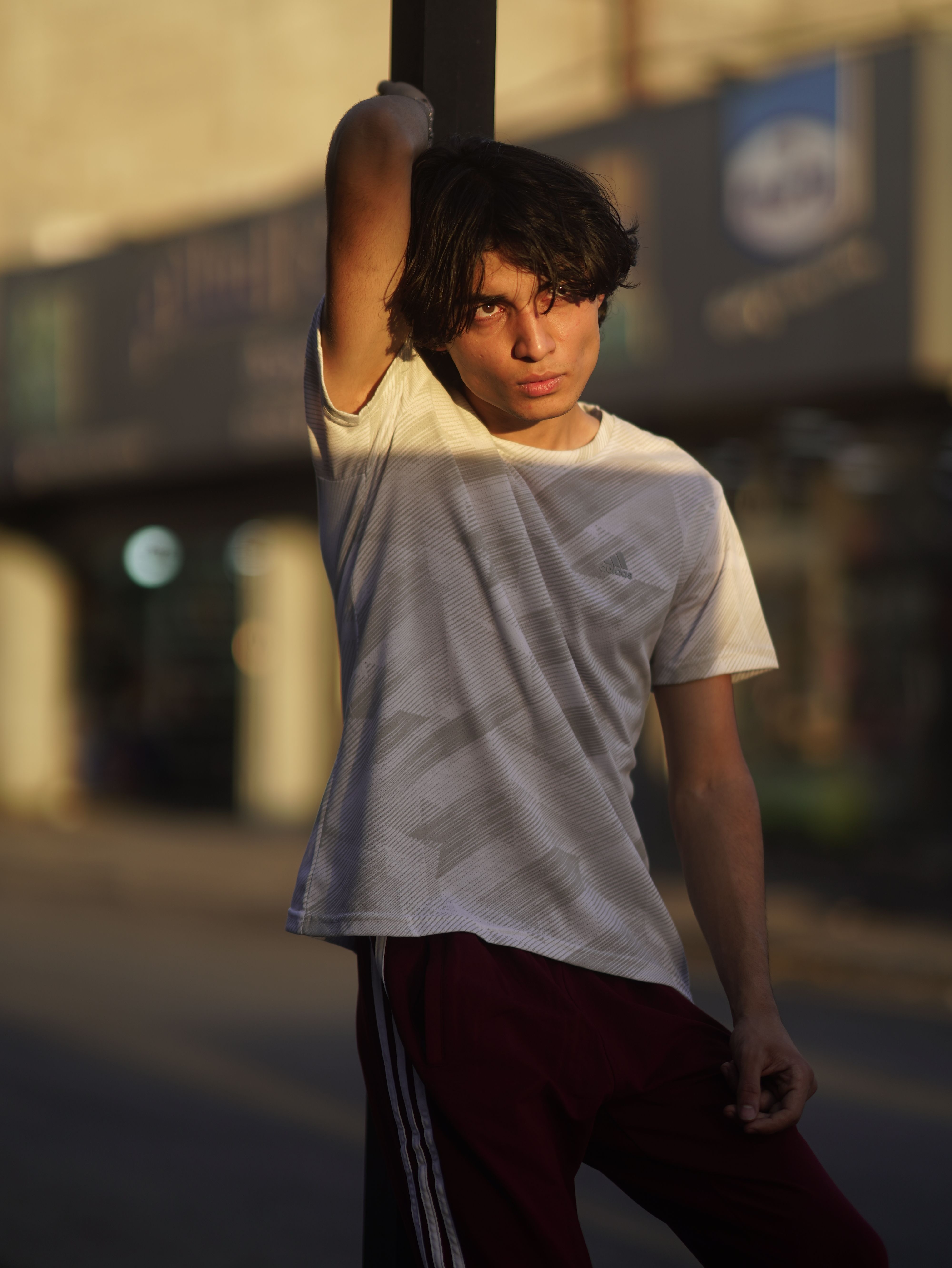 Man Leaning on Metal Post while Looking Afar · Free Stock Photo
