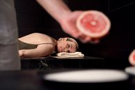 Woman Lying on Floor With Red Round Ornament