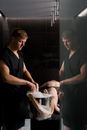 A Masseur in Black Robe Servicing a Client