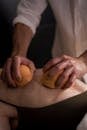 A Person Squeezing an Oranges on a Person's Back