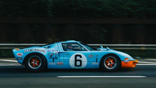 Free Classic Ford GT40 racing on the highway, showcasing vintage speed. Stock Photo