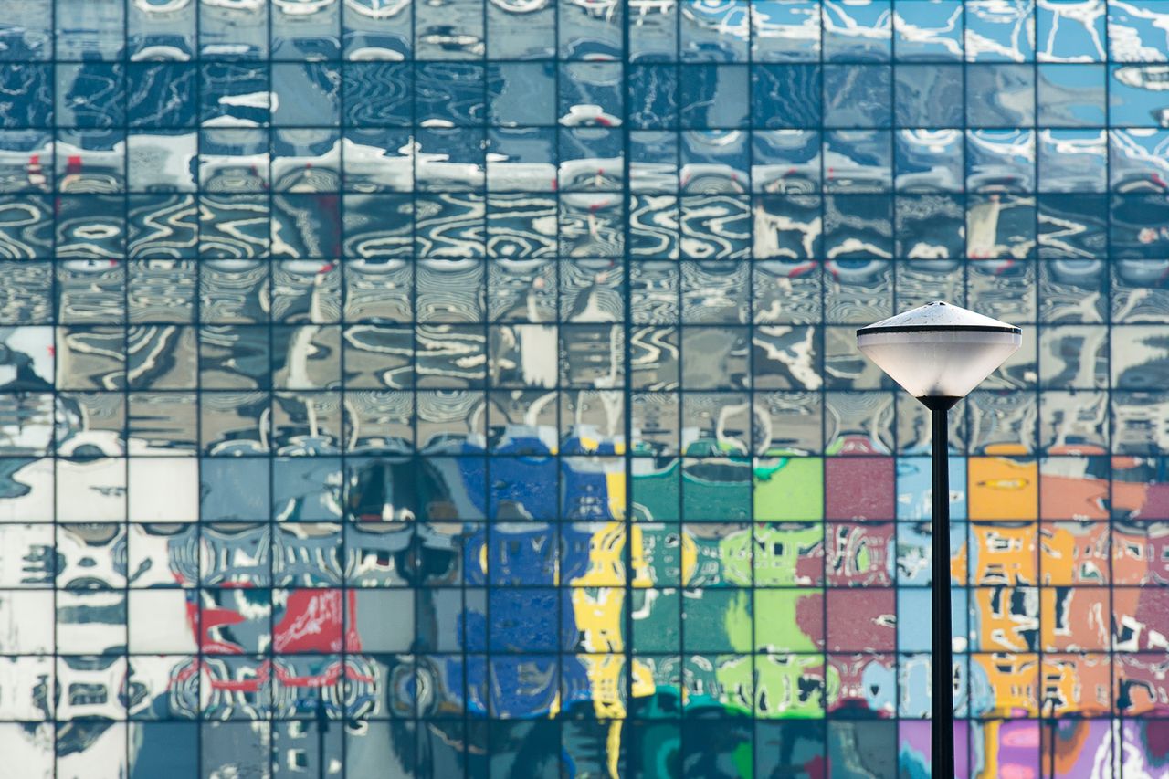 artistic reflection of a colorful building facade with a street lamp i