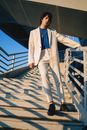 Man in White Suit Standing on White Concrete Floor
