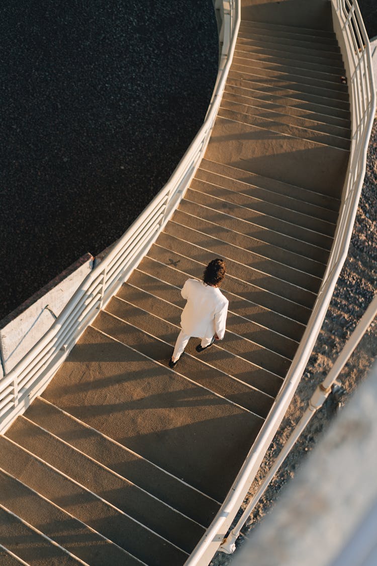 High Angle Shot Of Person Walking On Stairs 