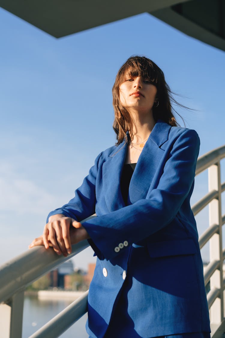 Woman In Blue Blazer Standing Near Hand Rails 