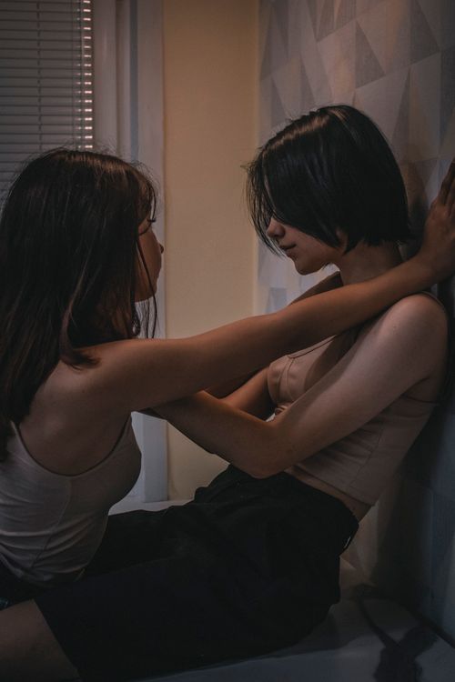 Free Two women sharing an intimate and emotional moment indoors, expressing affection and connection. Stock Photo