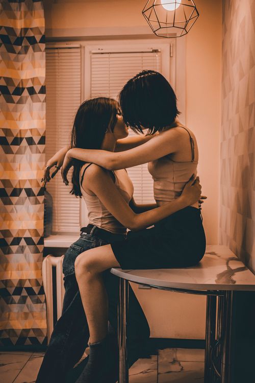 Free A tender moment shared by a couple in a cozy indoor setting, embracing affectionately. Stock Photo