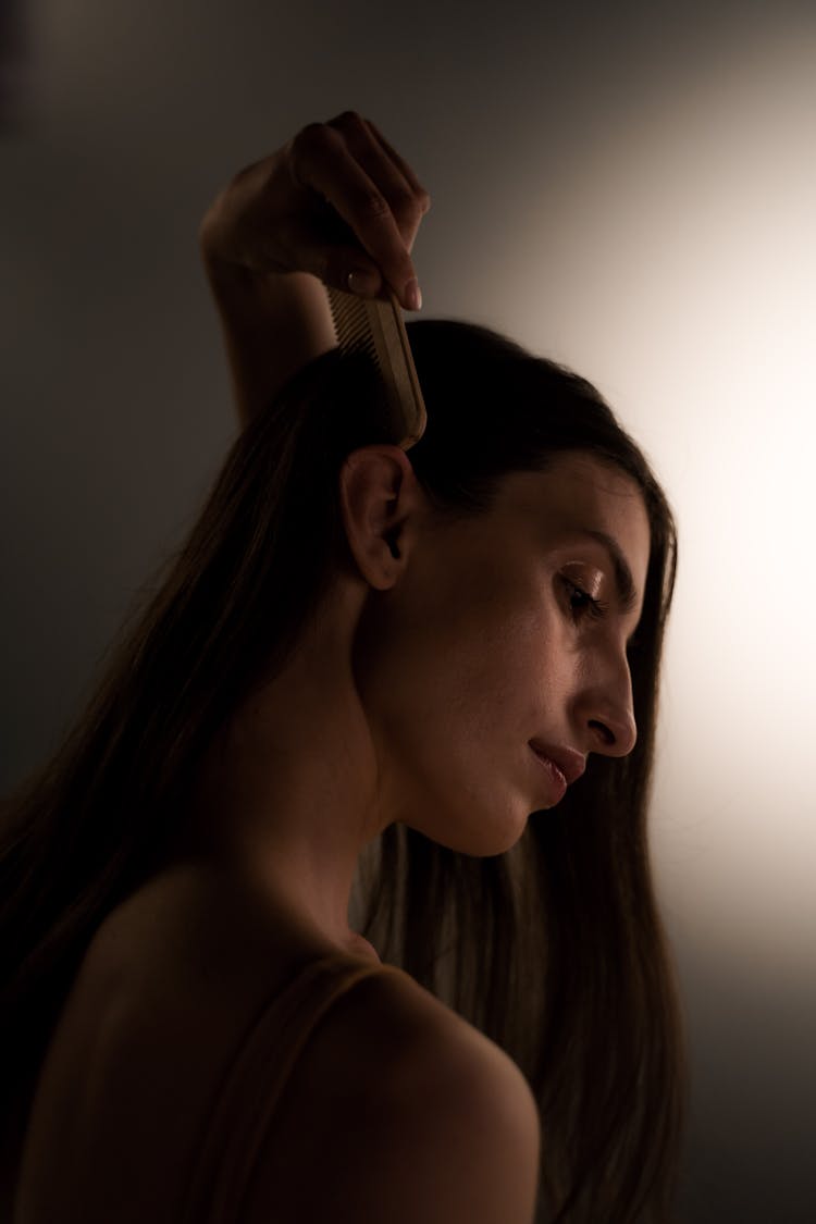 Beautiful Woman Combing Her Hair