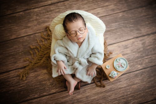 High-Angle Shot of Cute Baby Wearing a Bathrobe