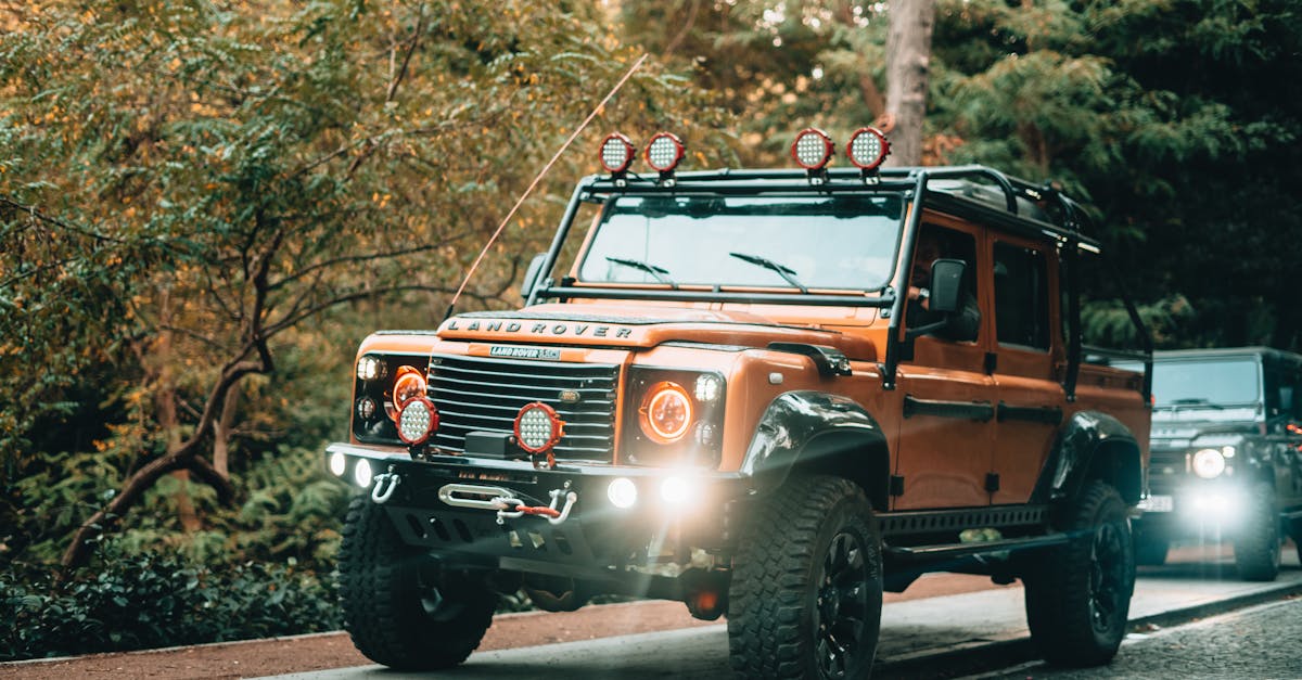 A rugged orange Land Rover driving through a forest road in Rize, Turkey.