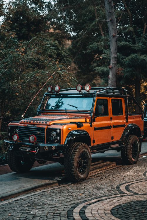 An Orange Land Rover Defender · Free Stock Photo