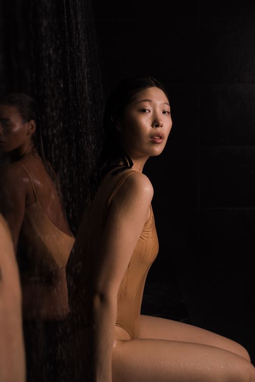 Free Portrait of an Asian woman in a bodysuit, embracing fashion with elegance. Stock Photo