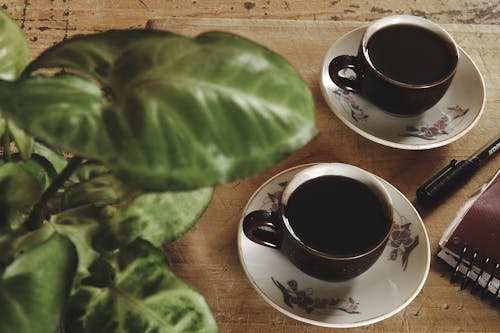 Cups of Black Coffee on Wooden Table