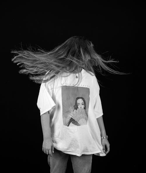 Free A Woman in White Shirt Covering Her Face with Her Hair Stock Photo