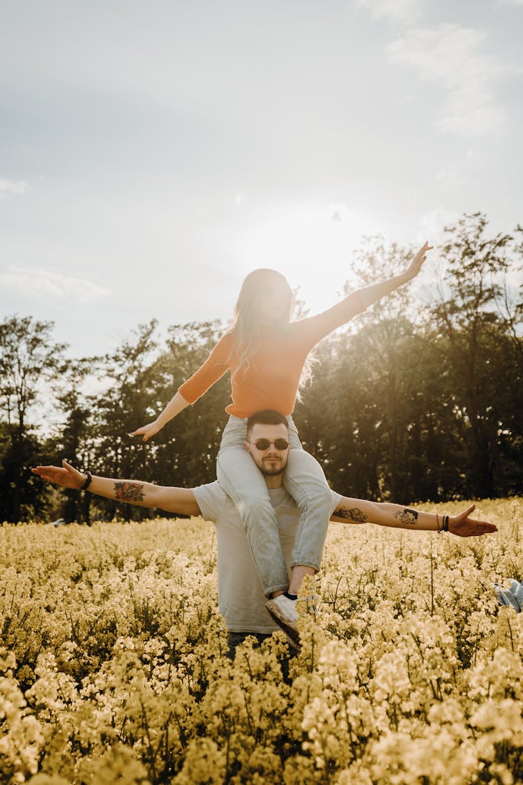 Man Carrying A Woman On Shoulders