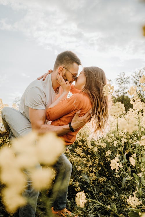 Couple Hugging Kissing in Field