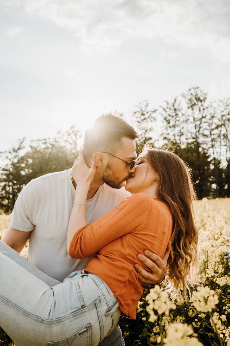 Couple Kissing While In A Grapeseed Field