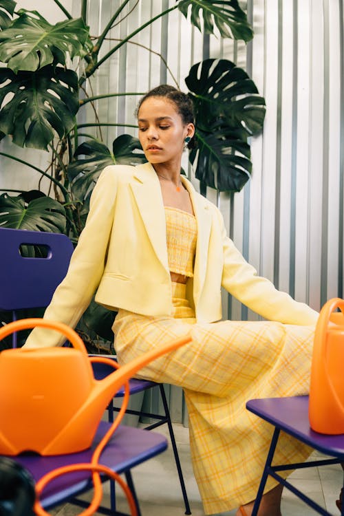 A Woman in Yellow Blazer Sitting on Chair