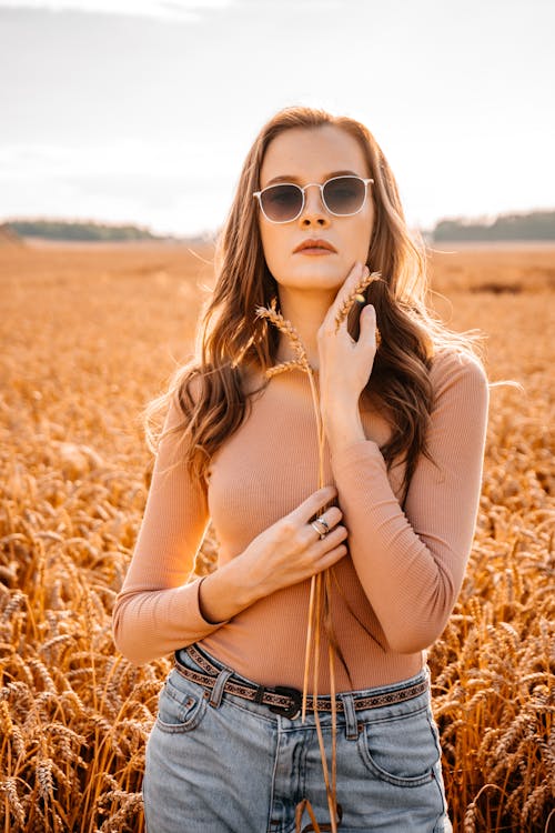 Woman Holding Wheat on Wheat Field