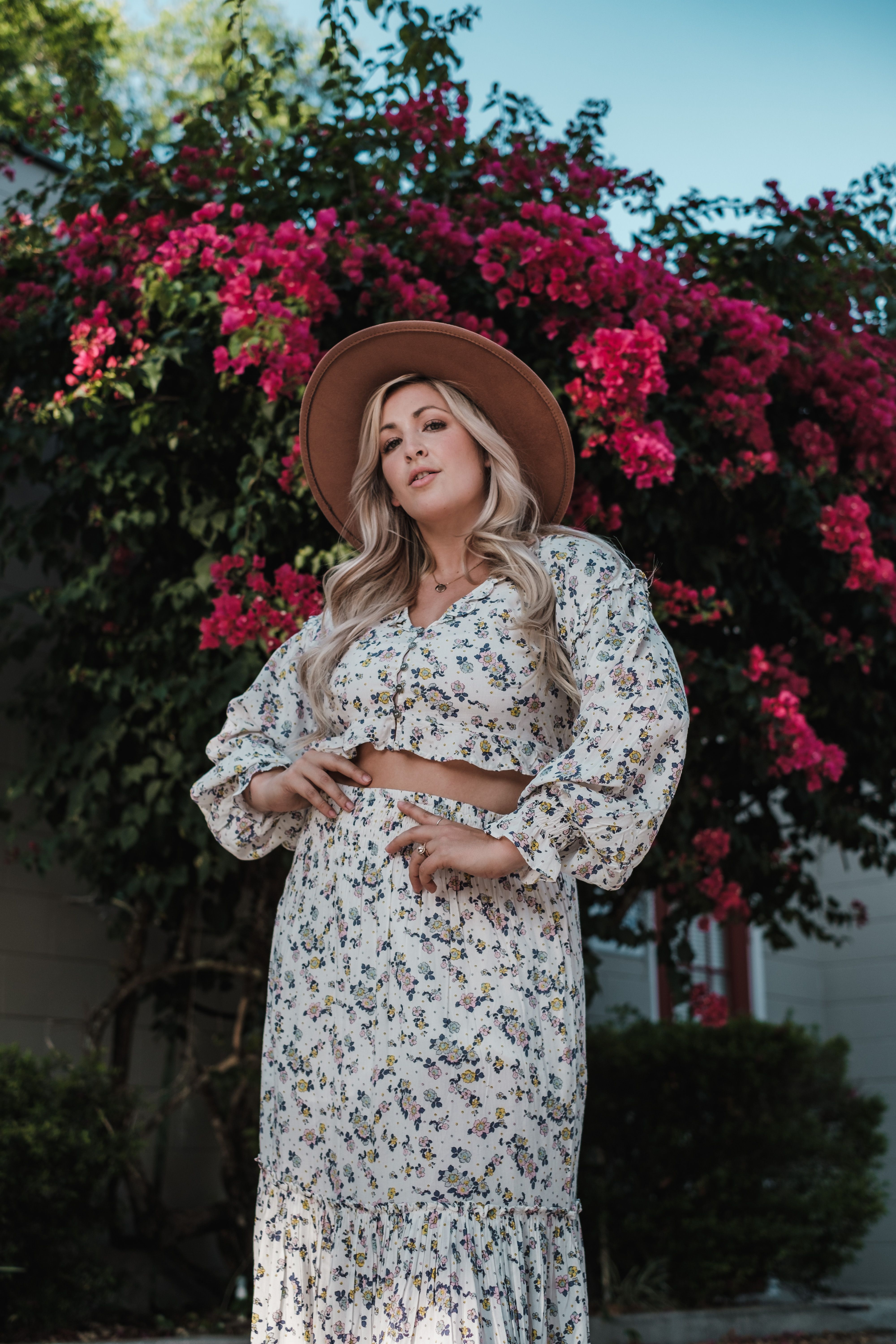 Woman in White Floral Dress Posing · Free Stock Photo