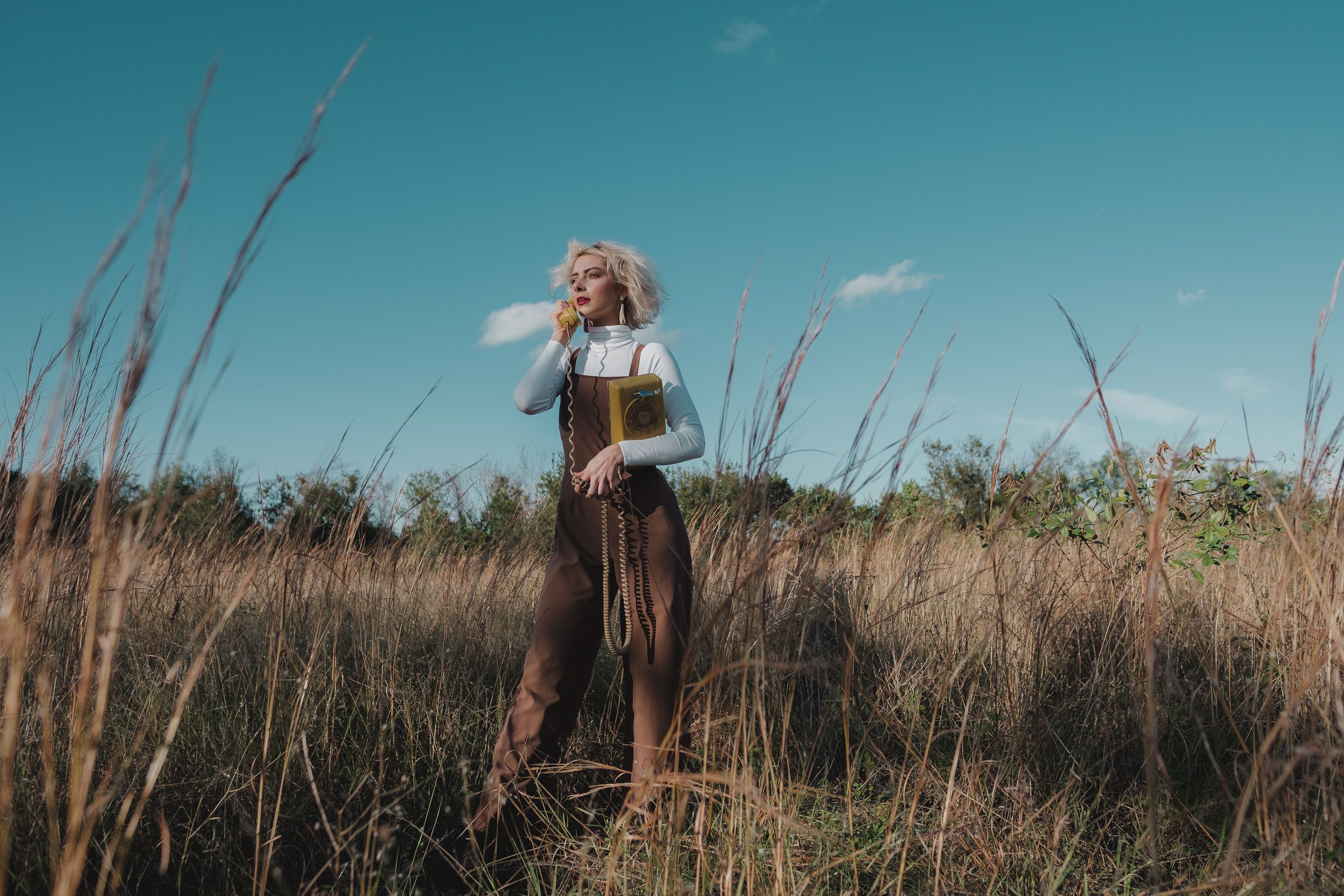 A Woman in Brown Jumpsuit Standing on Brown Grass · Free Stock Photo