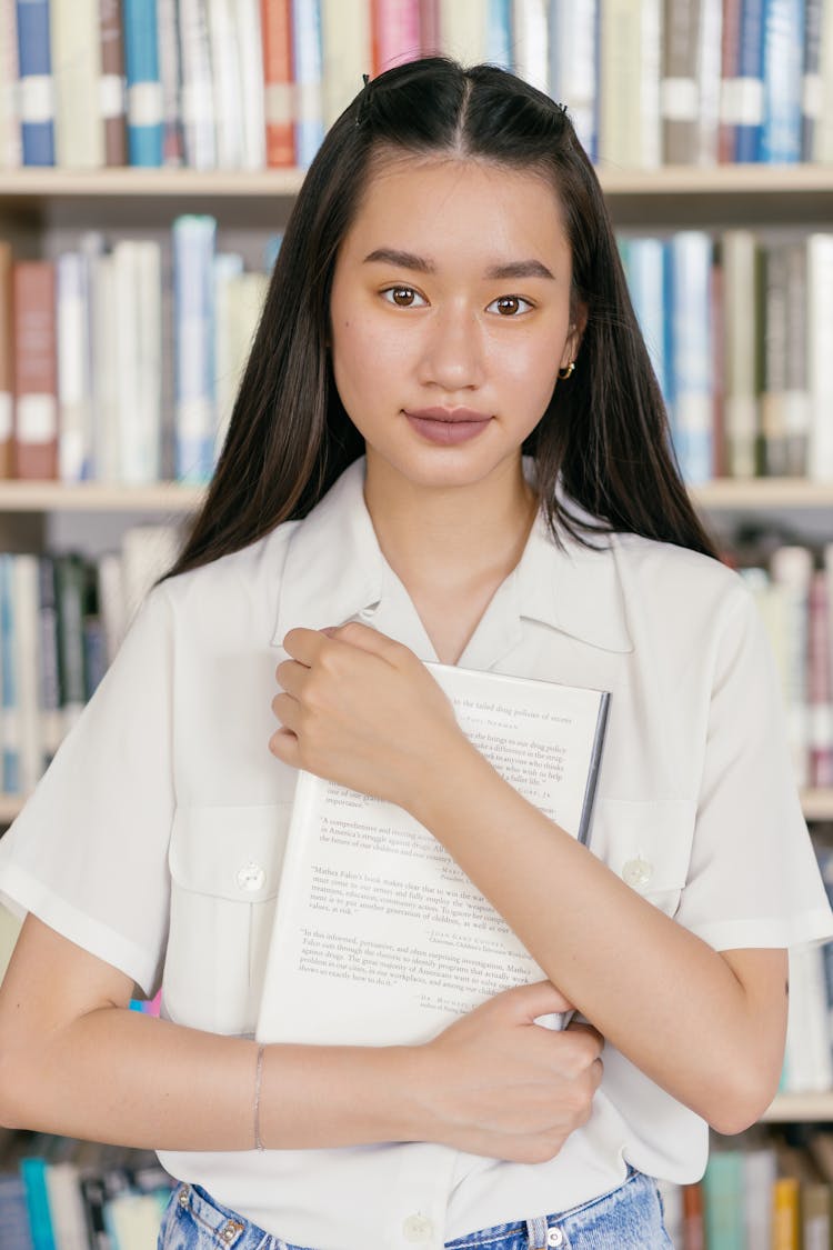 Female Student Holding A Book