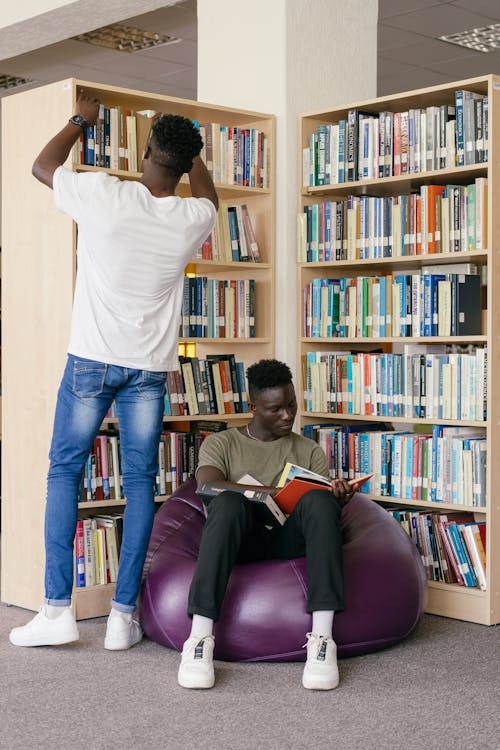 Men in the Library Holding Books