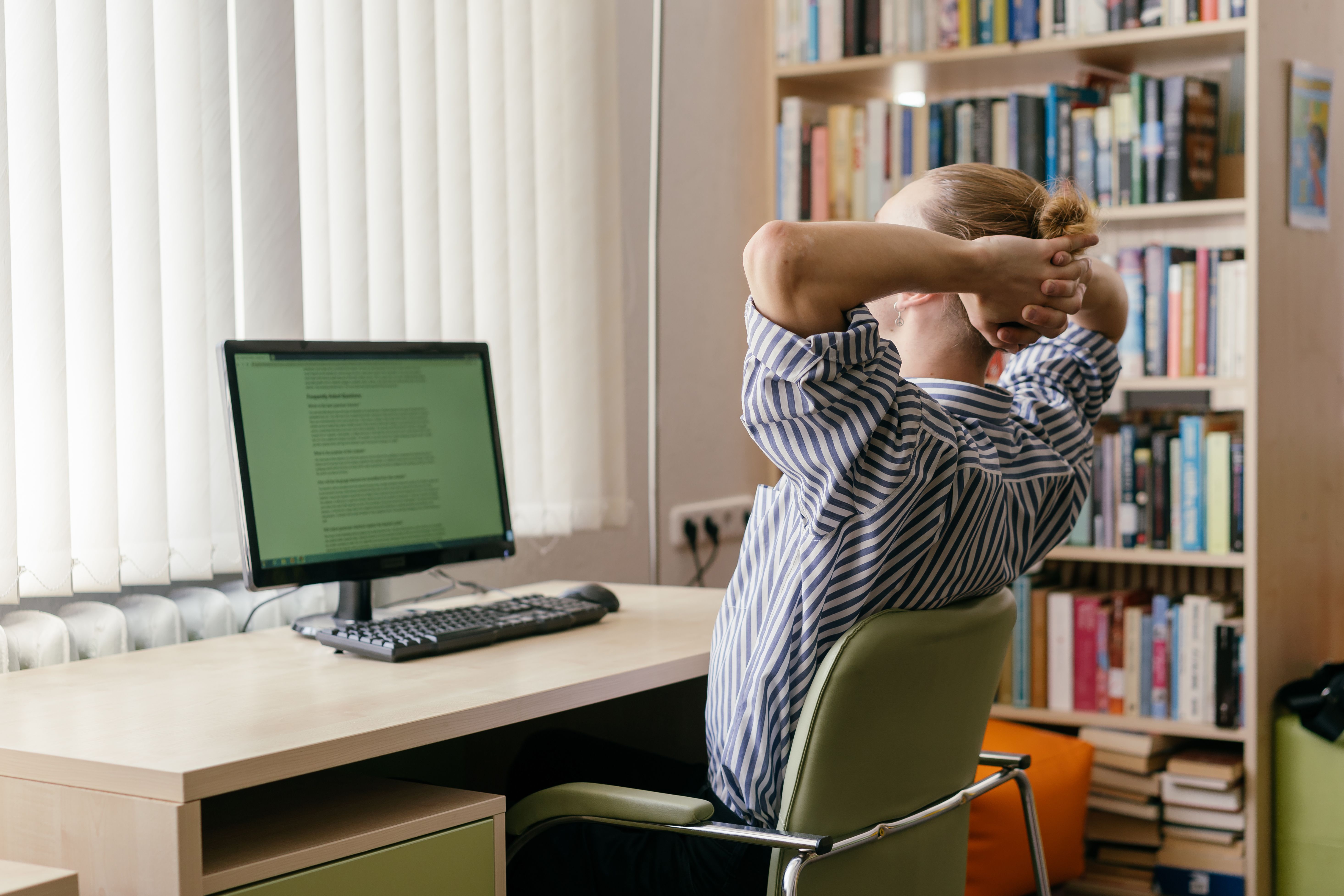 A person working on their computer in a home office.