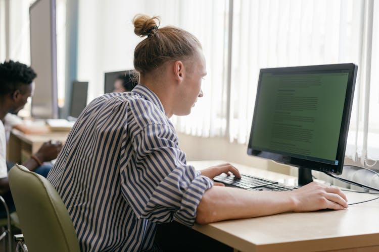 A Male Student Using A Computer