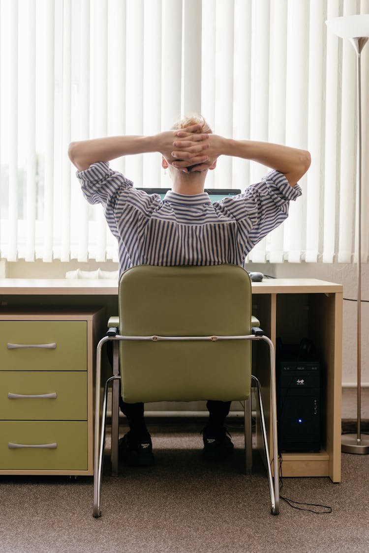 Back View Of A Person Sitting On Chair