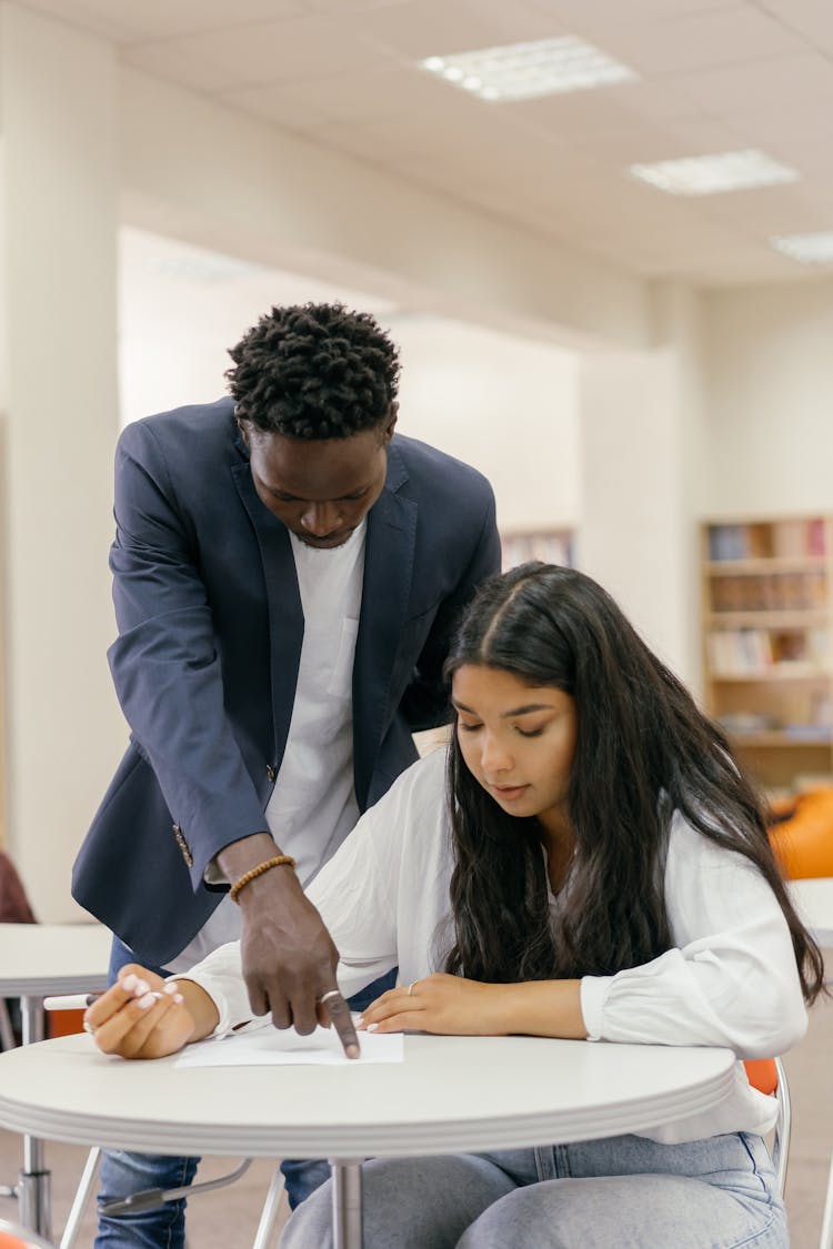 A Male Teacher Teaching His Female Student