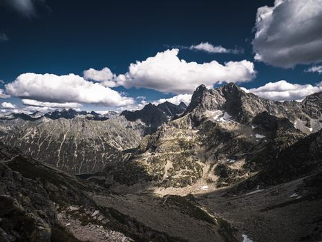 Stunning rocky mountain range under dramatic clouds, ideal for nature enthusiasts.