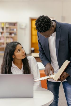 Student studying with books and a laptop