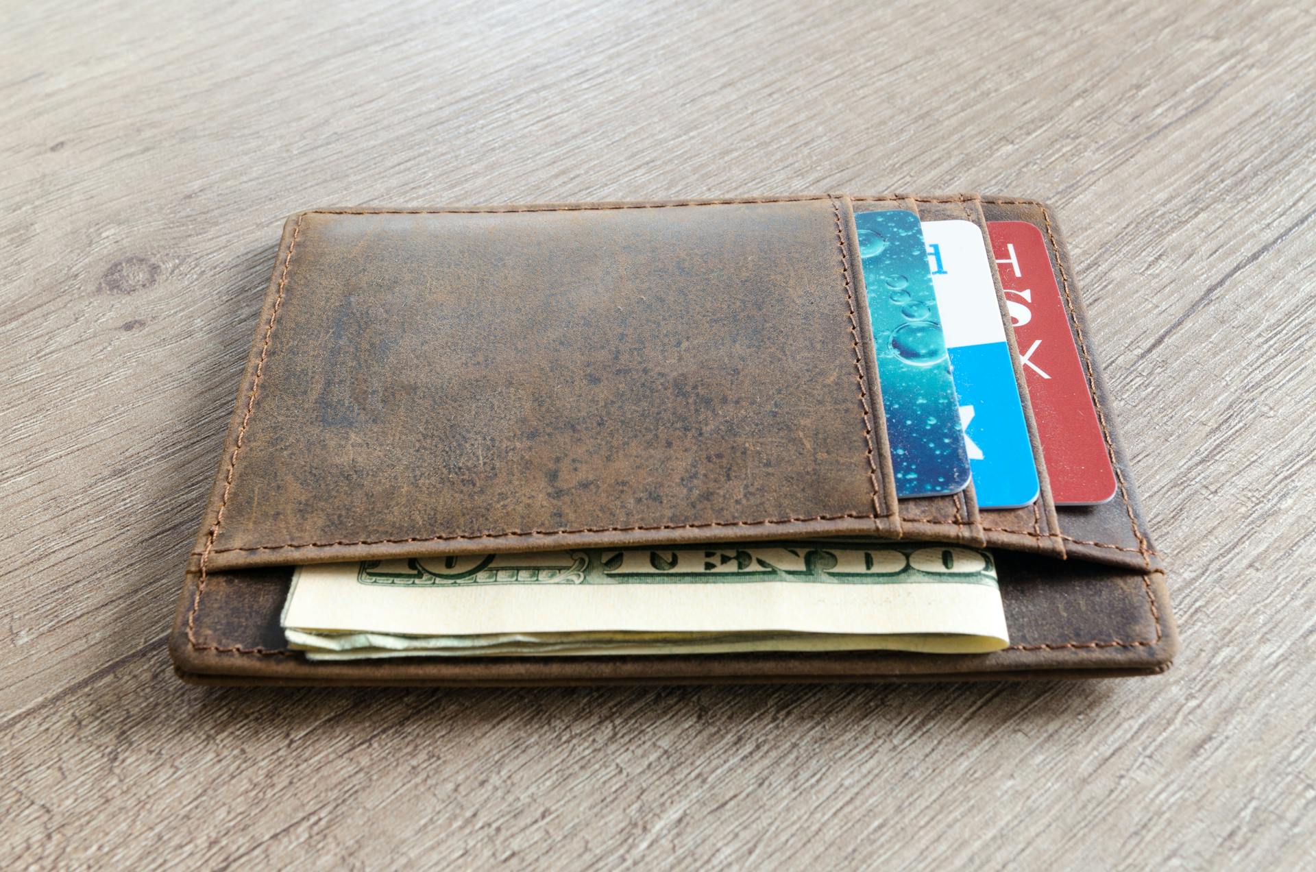 Brown Leather Wallet and Us Dollar Banknote