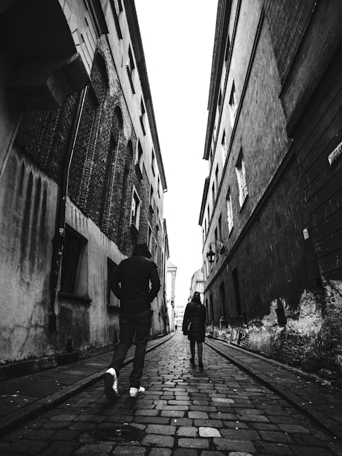 Free Grayscale Photo of Two People Walking on Street Stock Photo