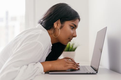 Close-Up Shot of a Woman Using a Laptop