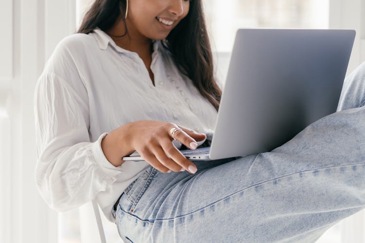 Close Up Photo Of Woman Holding A Laptop