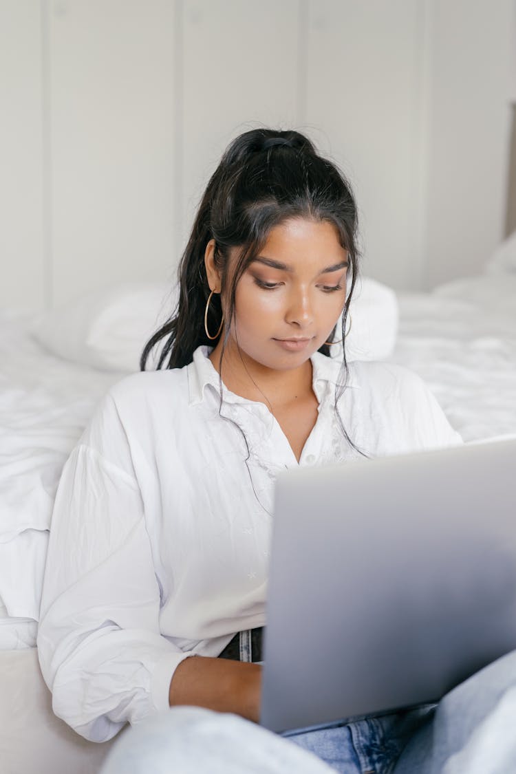 Beautiful Woman Using Laptop In Bed