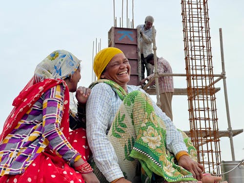 Two Women in Traditional Clothes Laughing Together