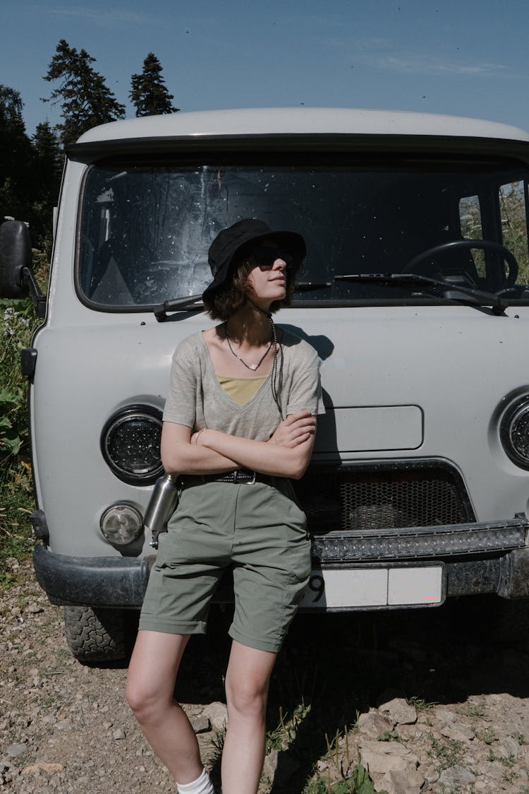 A Woman Standing In Front Of A Vehicle